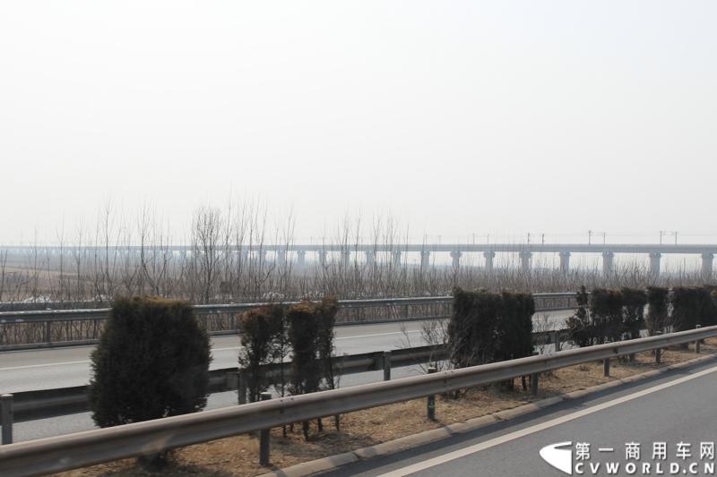 在山海关服务区稍作休整后，奔驰卡车继续南下。图为北京至广州的高速铁路铁架桥。