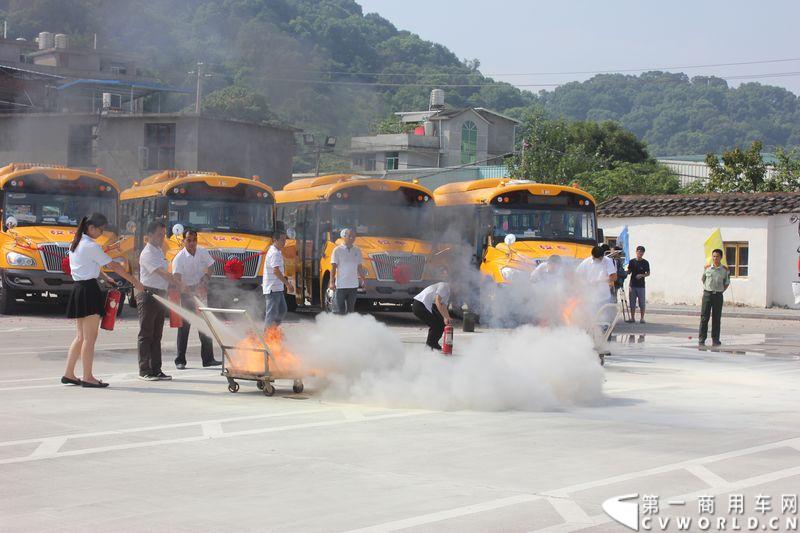8月24日，福州康驰新巴士有限责任公司（简称康驰公司）旗下的8条“5i84”定制校车线路正式开通仪式在康驰公司齐安停车场举行。据介绍，康驰公司采购了9辆全新的宇通校车，一共开通了8条定制校车线路。图为校车车长们与照管员们进行灭火训练